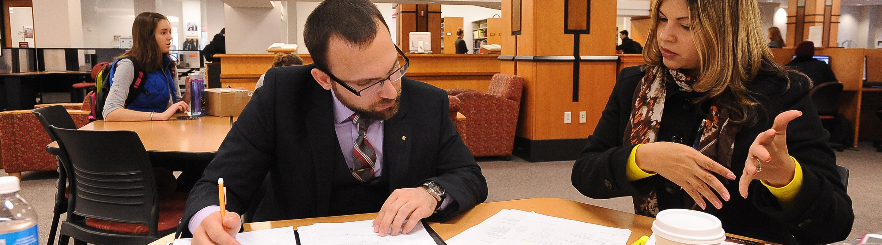 Two students reviewing papers
