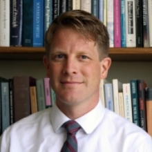 Jonathan Peterson on background of old books