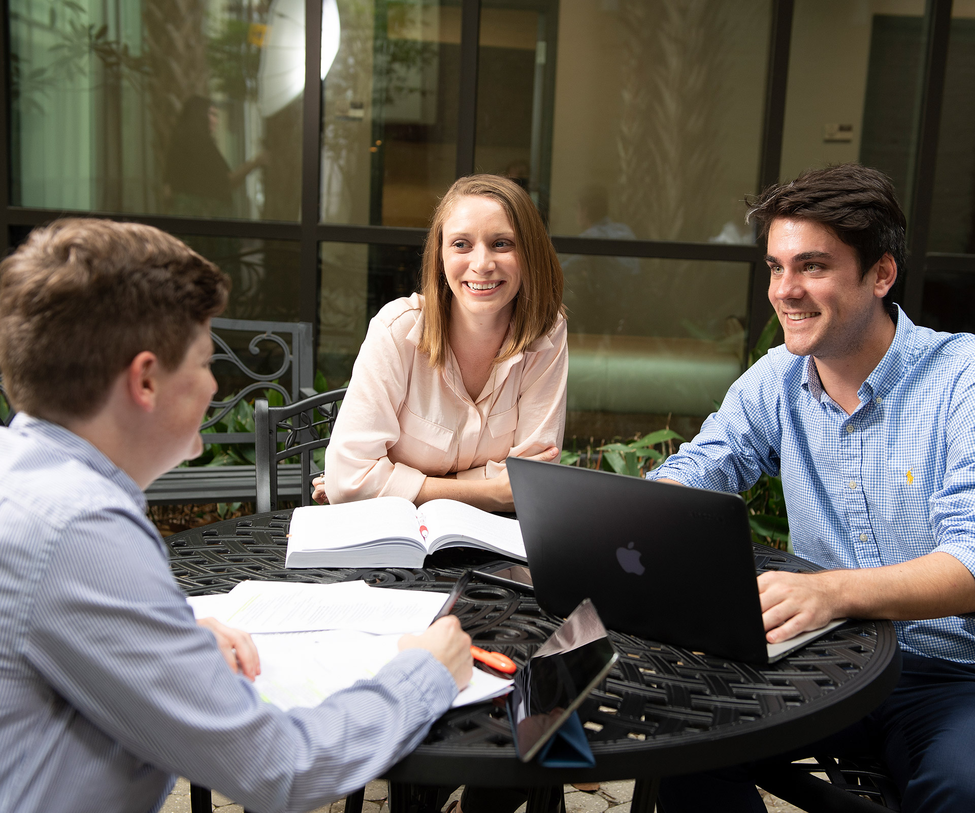 Students outside studying and discussing law 
