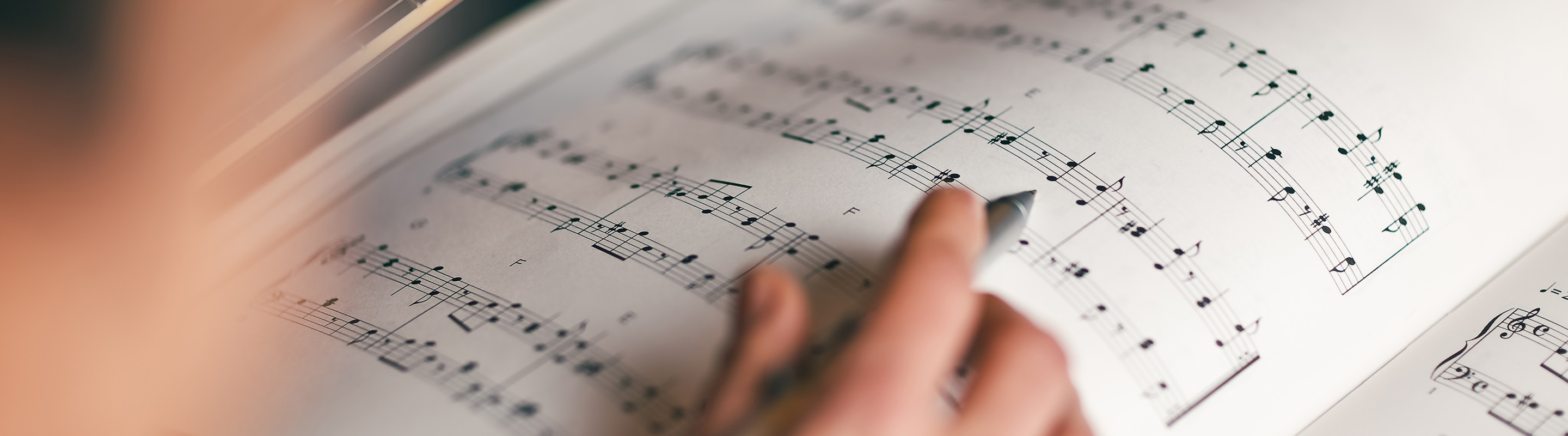 hand poring over sheet music