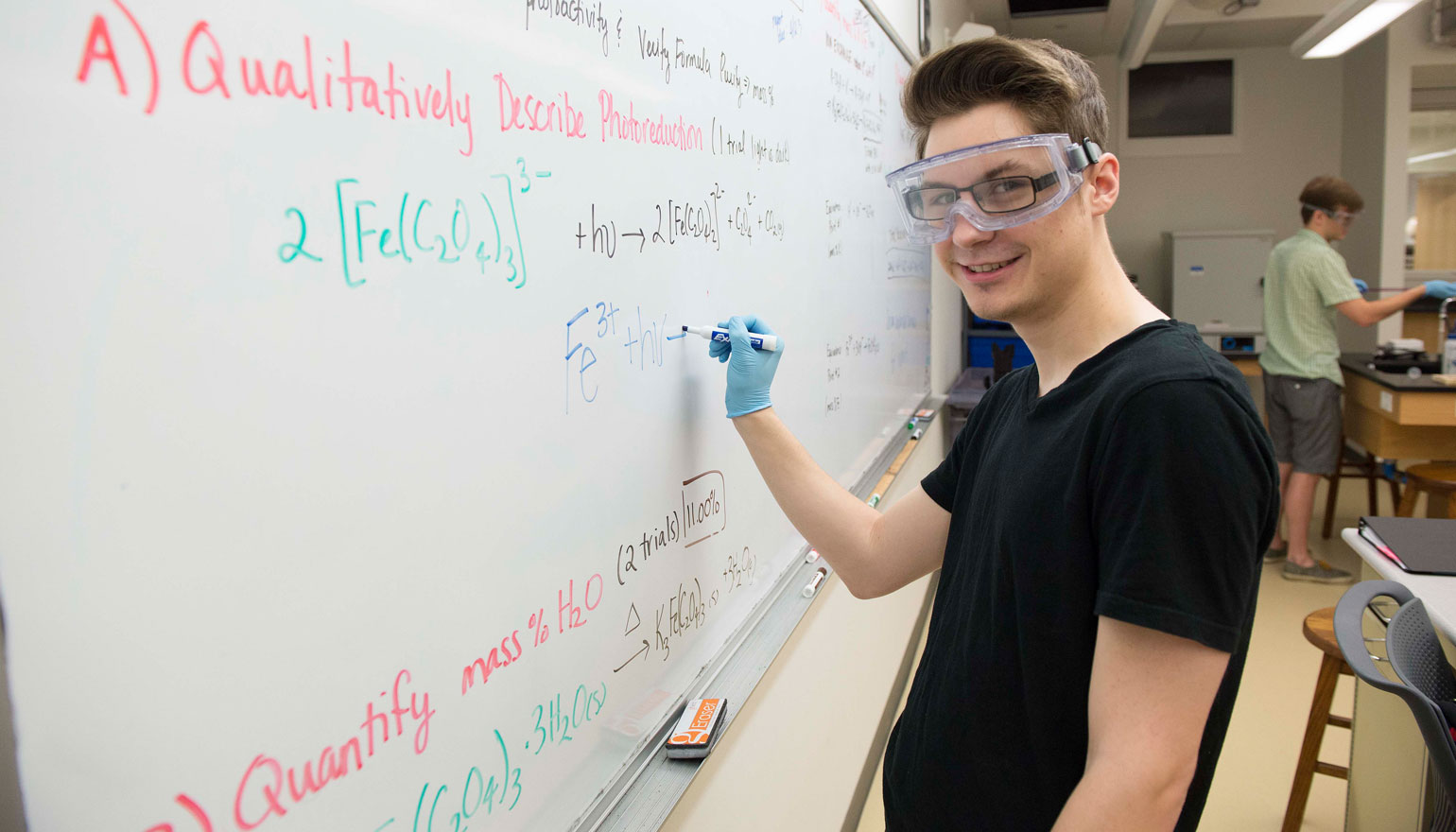 Student writing down an equation