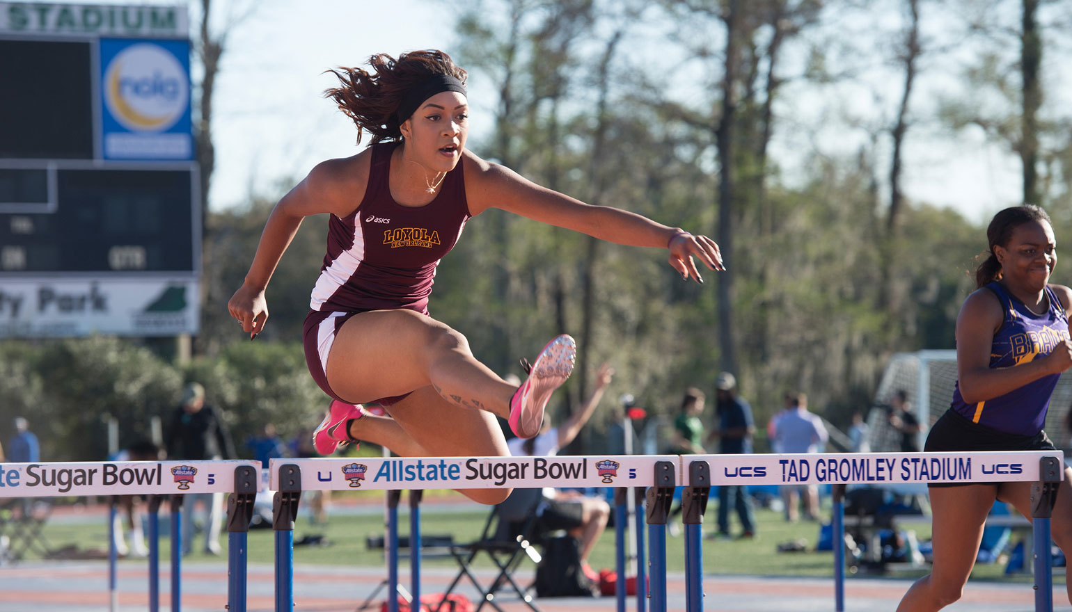 Student athlete completing hurdles