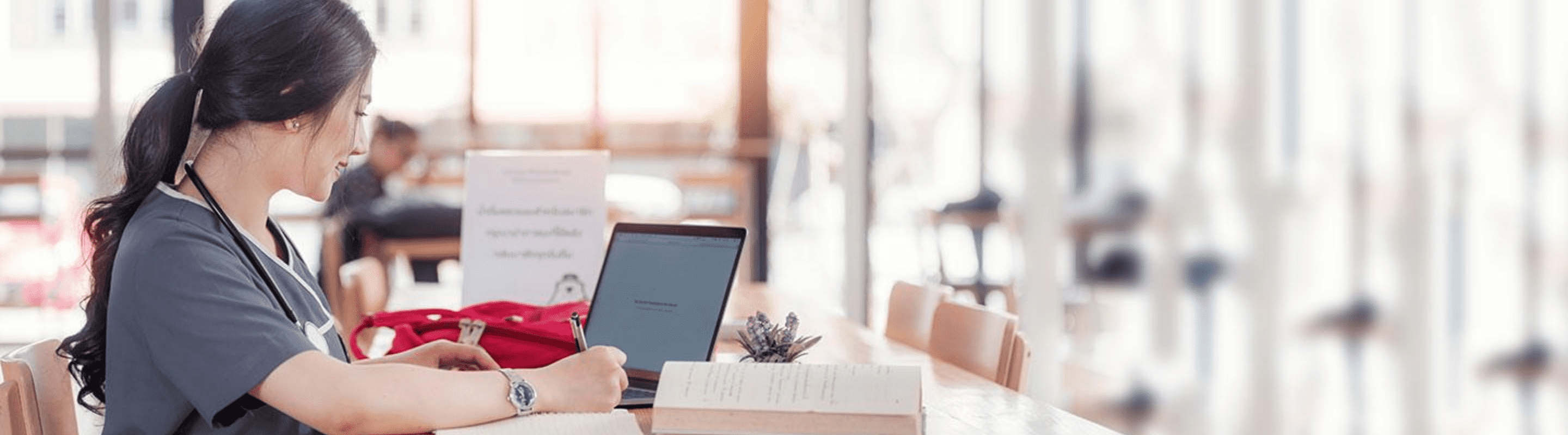 Online nursing student studying with her laptop.