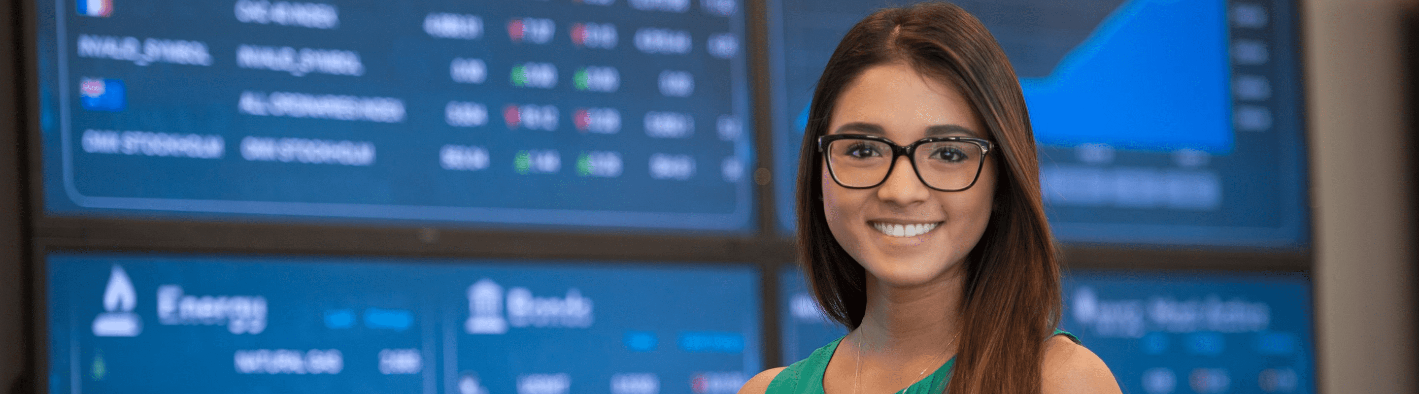 Online international business student in front of business stock tape.