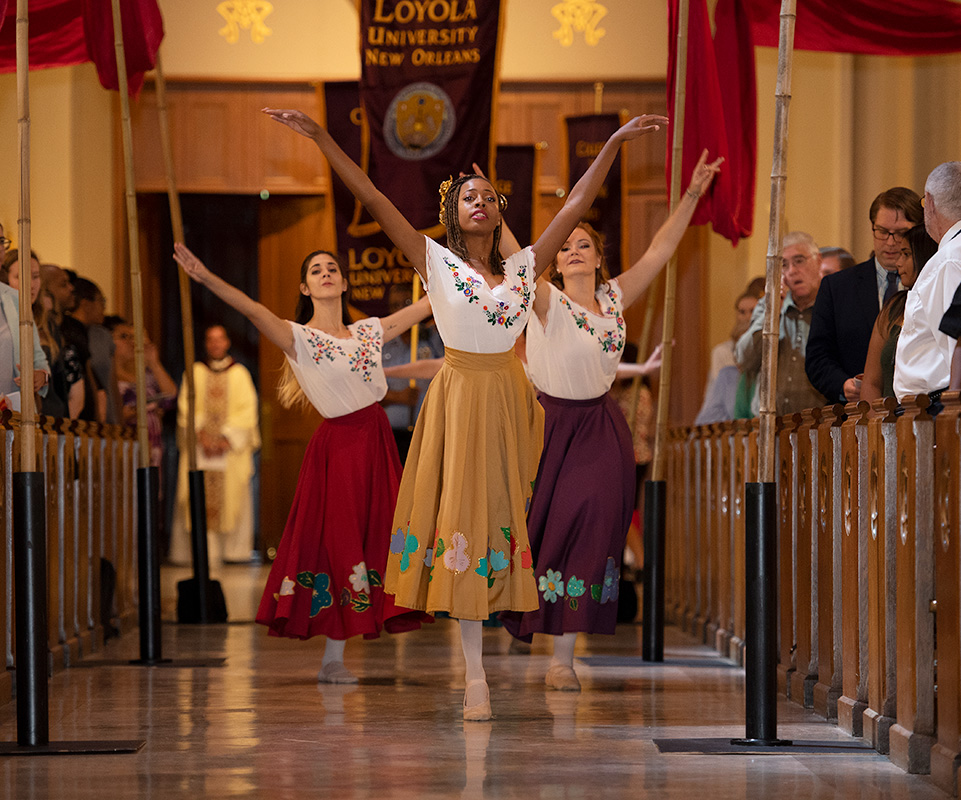 Students dance down the aisle during the Mass of the Holy Spirit