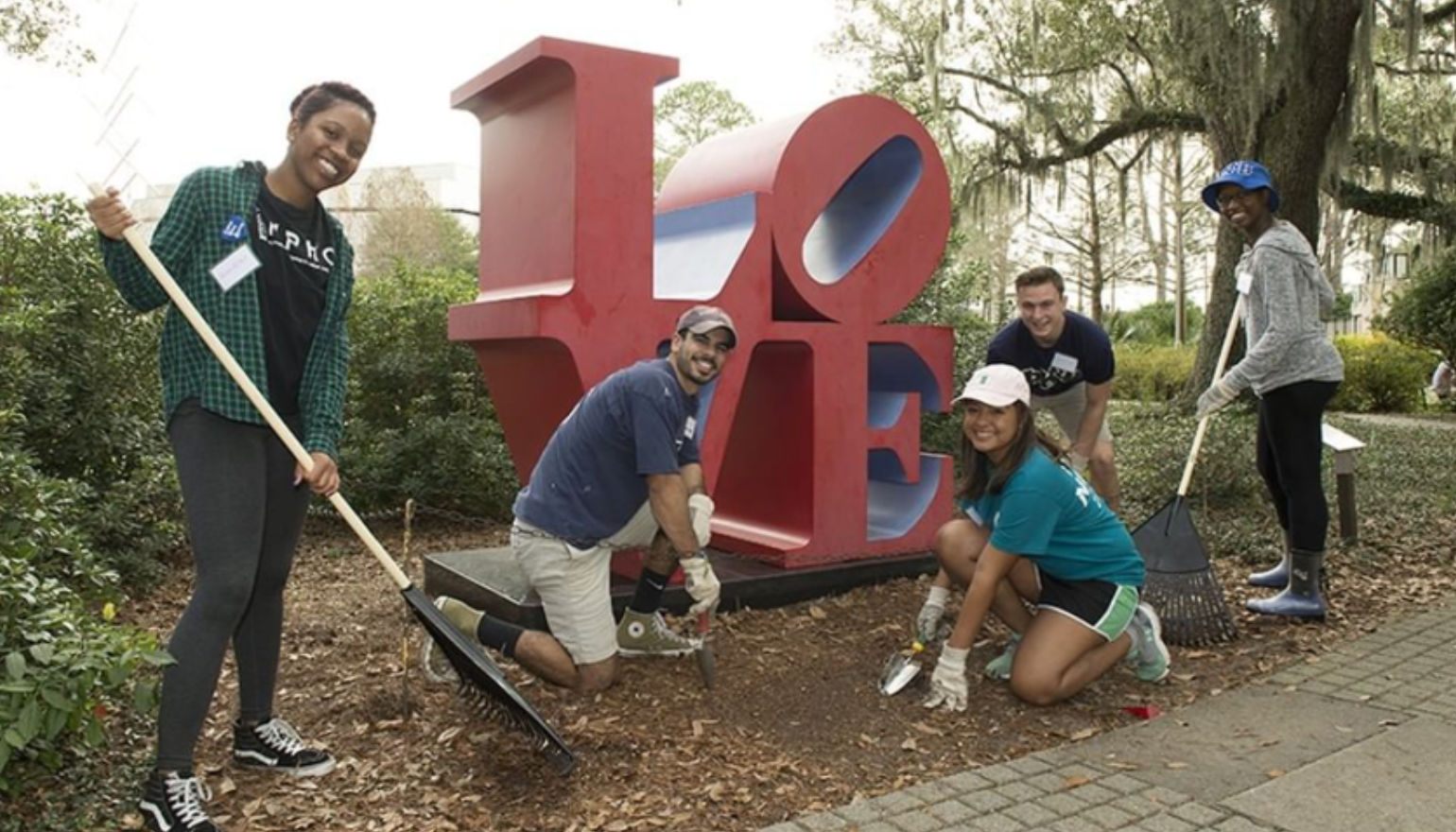 Graduate students gardening during homecoming week