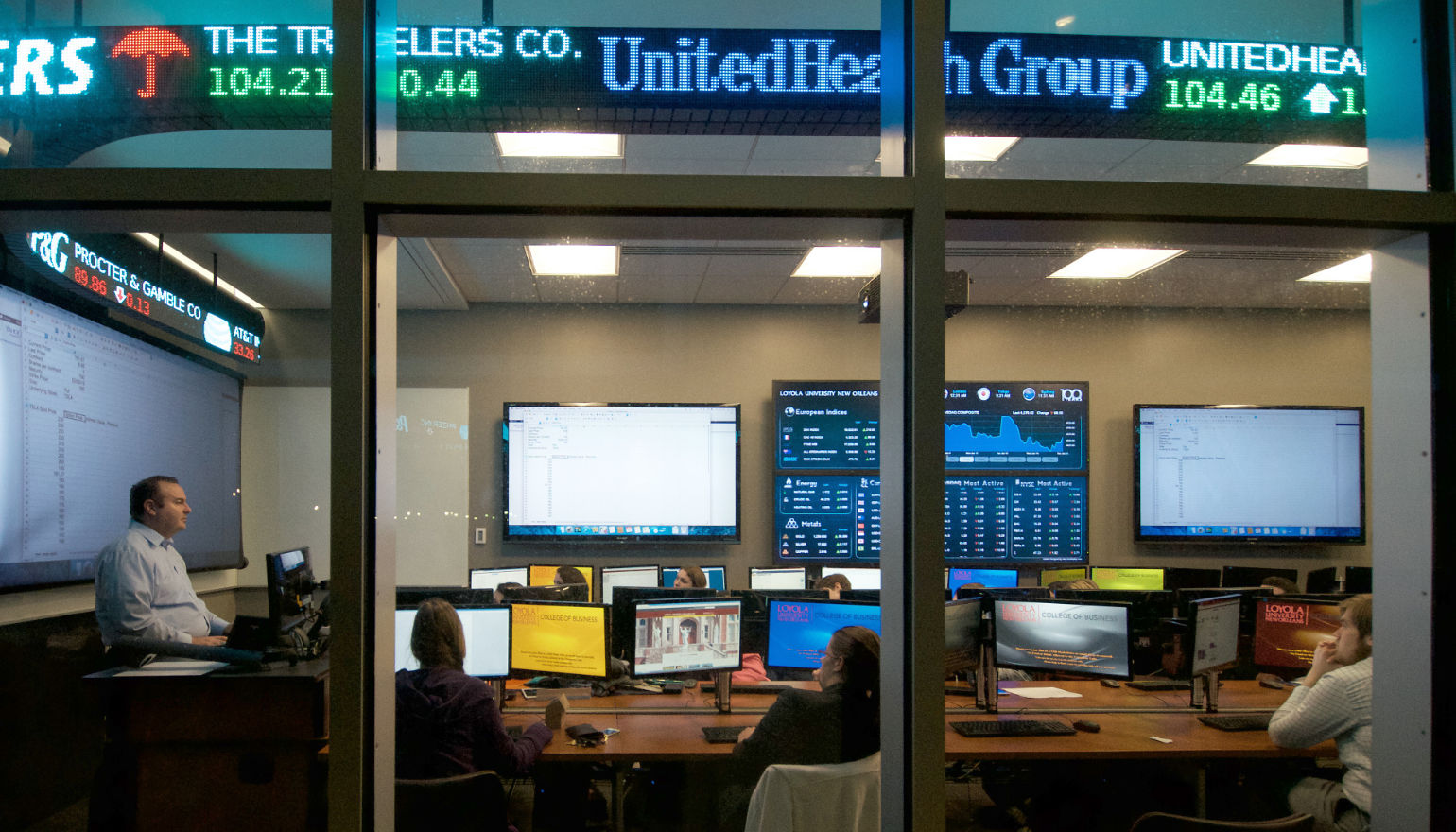 Graduate students taking a class in Loyola's stock room