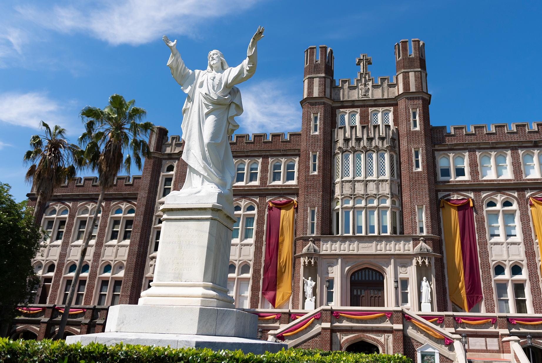 front of Marquette Hall with statue of Jesus
