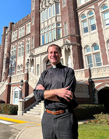 Fr. Daffron outside Marquette Hall